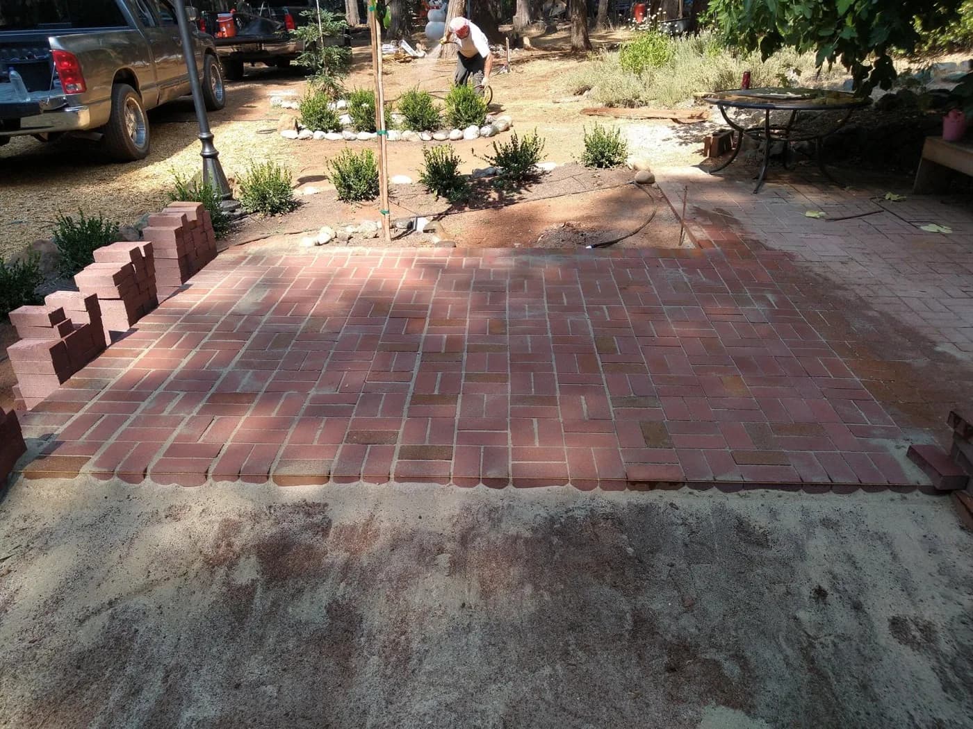 Brick patio we laid in a running bond pattern beside a raised planter