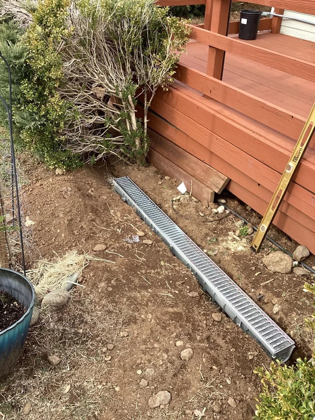 Channel drain and grate we set along a fence line to move surface water
