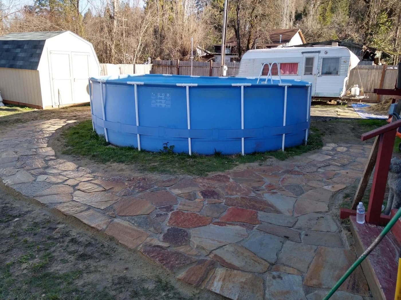 Flagstone path and landing laid around an above-ground pool
