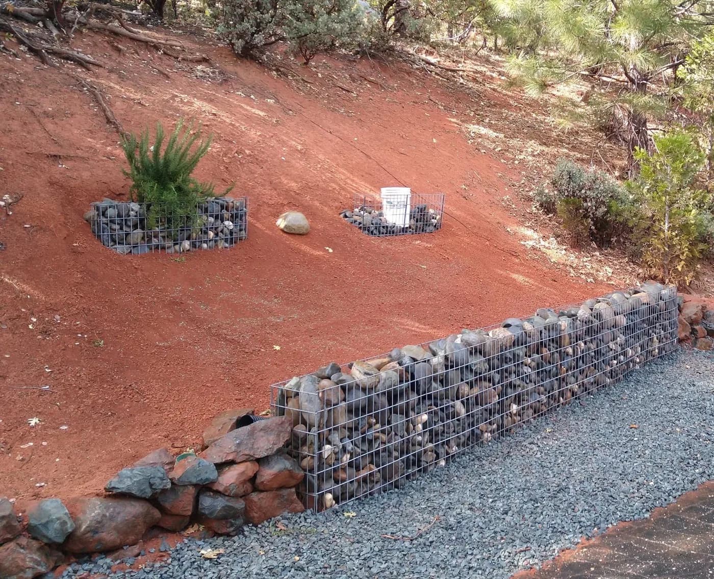 Gabion wall of wire-caged rock we built along a gravel drive