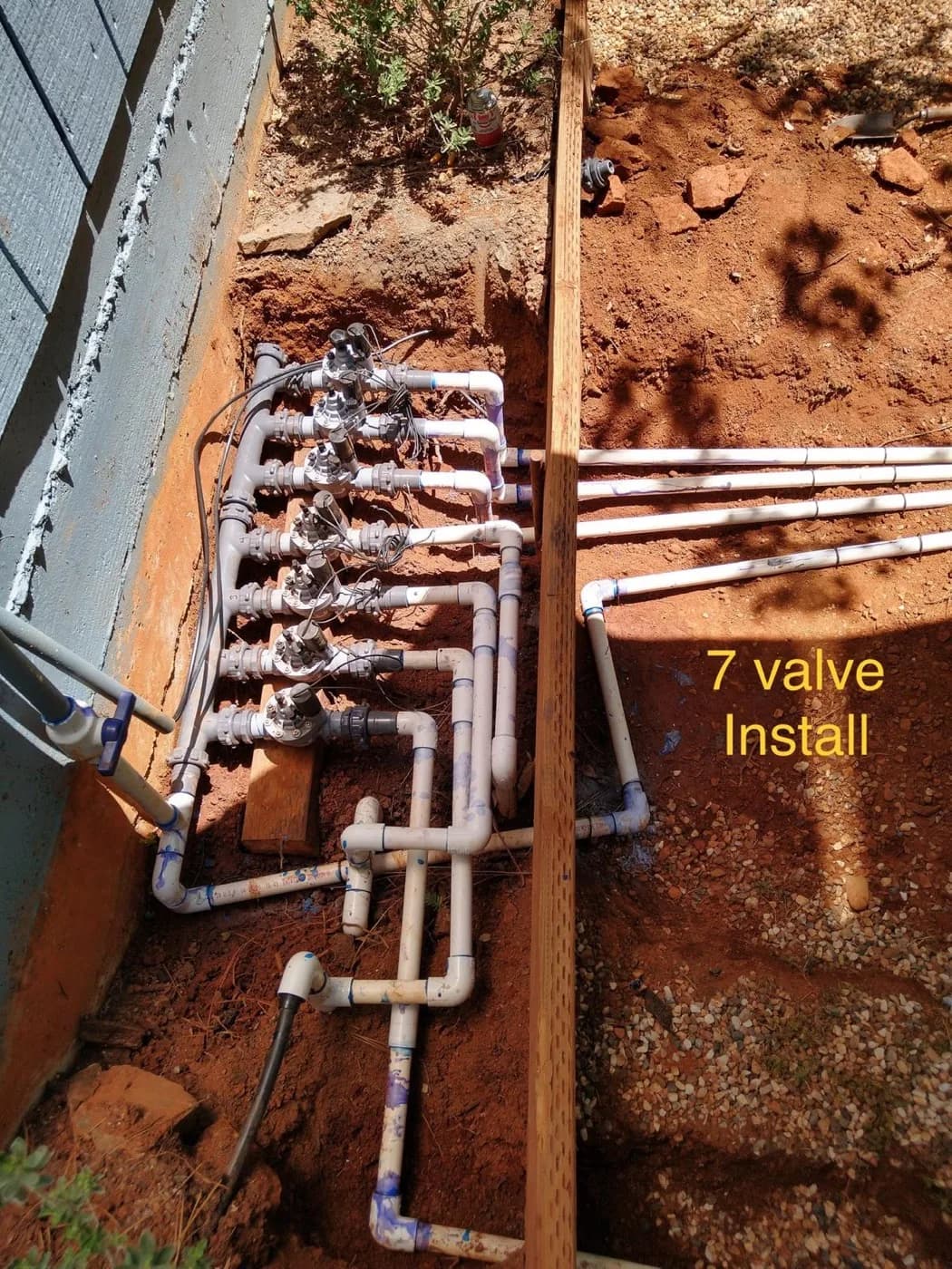Seven-valve irrigation manifold assembled in an open trench