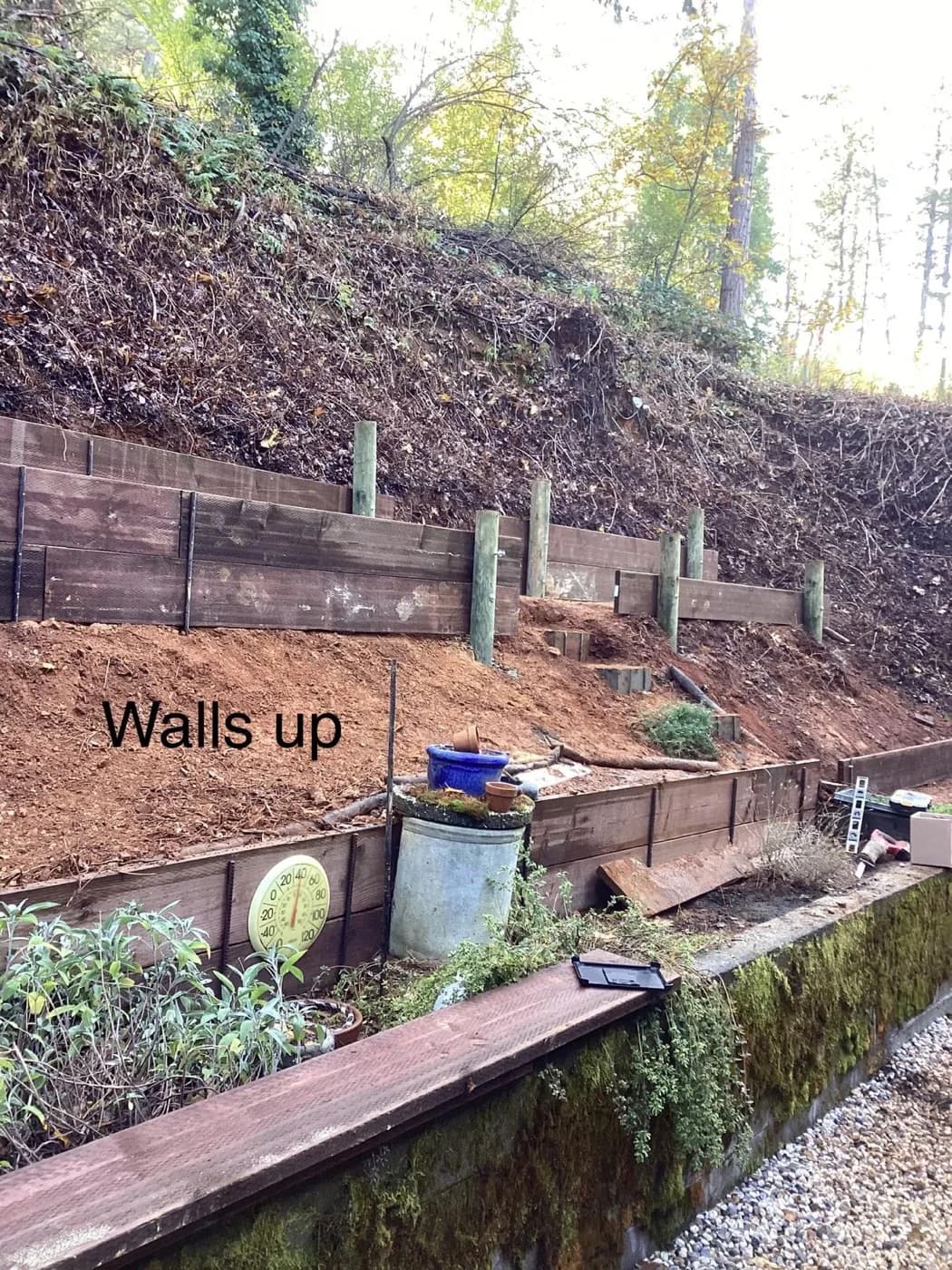 Timber retaining wall we set in tiers across a cut hillside