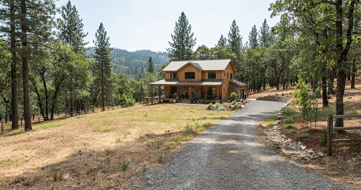 A foothill home with completed clearing around it, showing open ground near the house and daylight between the tree canopies